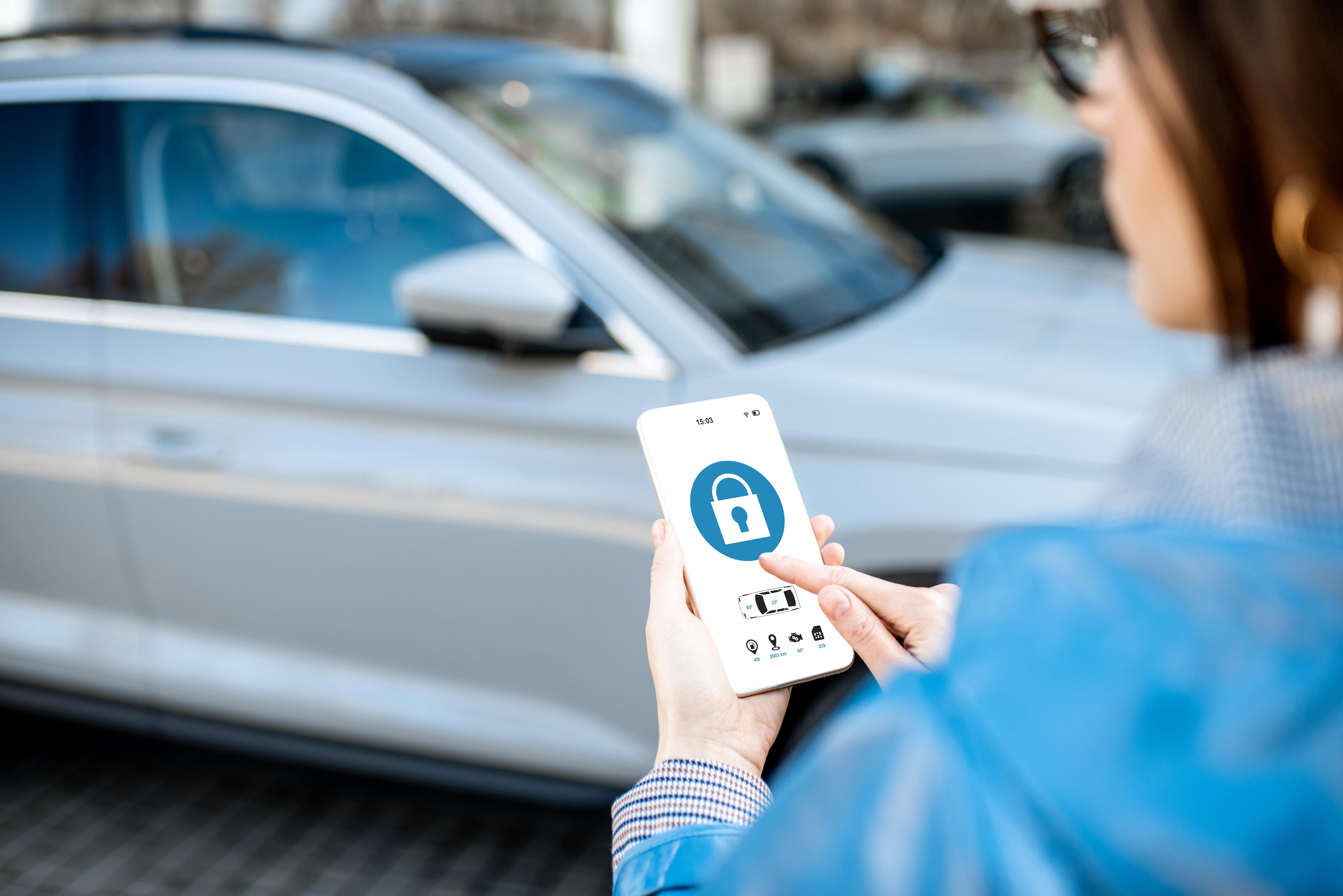 woman using app to unlock car with identity management program