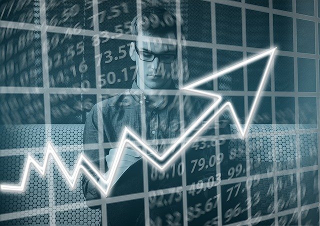 man behind expenses graph with arrow pointing up